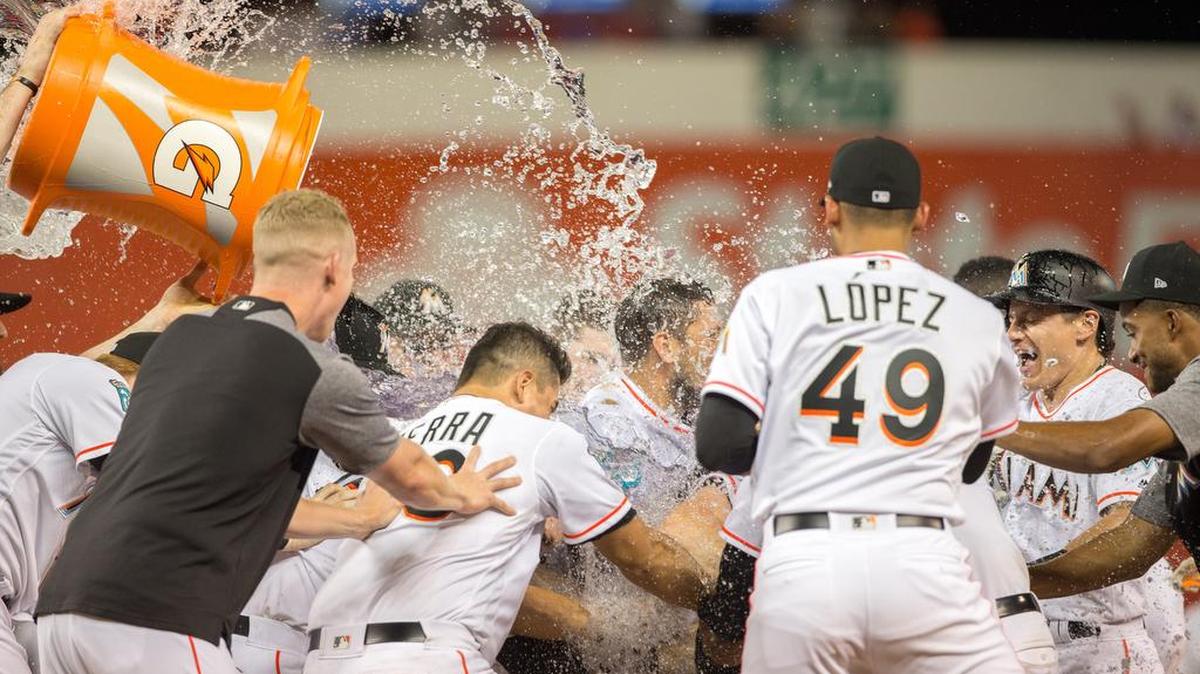 Miami Marlins celebrate after a walk-off single by Miami Marlins catcher Bryan Holaday (28) against the Brewers to win the game in the 10th inning 4-3 at Marlins Park in Miami, Monday, July 9, 2018.