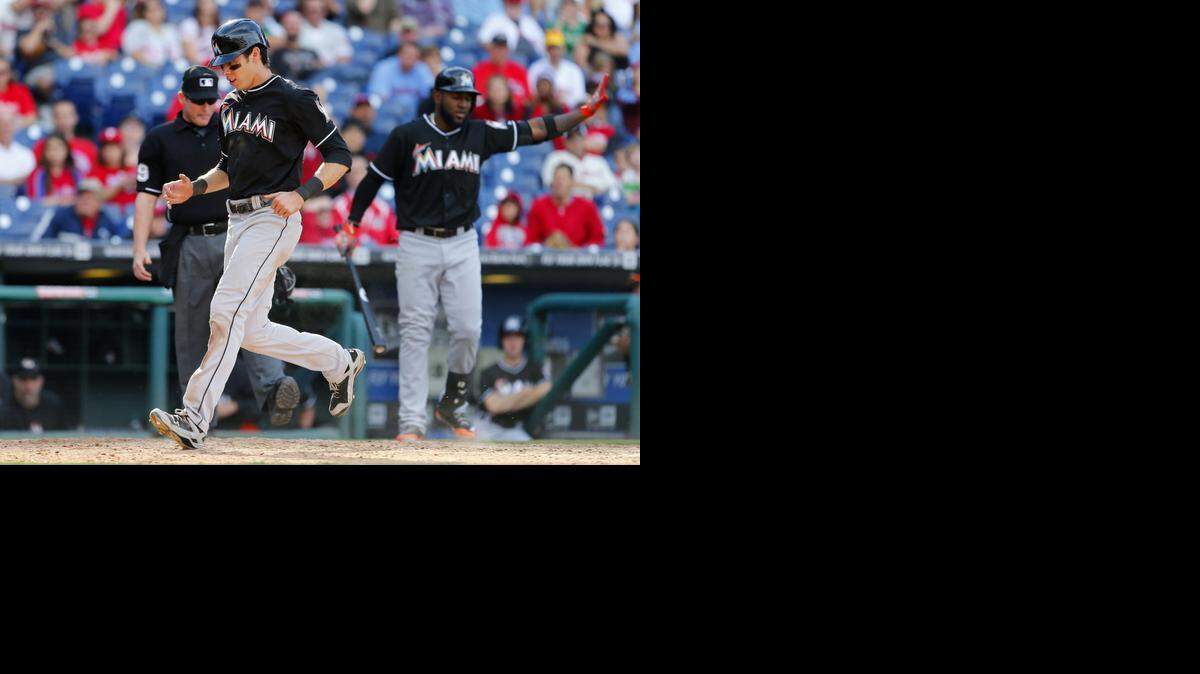 
Christian Yelich #21 of the Miami Marlins scores on a wild pitch by Jonathan Papelbon #58 of the Philadelphia Phillies during the ninth inning of a game at Citizens Bank Park on September 14, 2014 in Philadelphia. The Marlins defeated the Phillies 5-4. 
