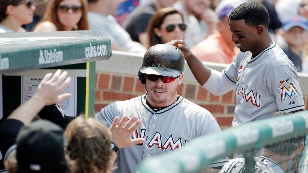 
Justin Bour of the Miami Marlins is congratualted by teammates after hitting a solo home run against the Chicago Cubs during the sixth inning at Wrigley Field on July 3, 2015 in Chicago, Illinois.
