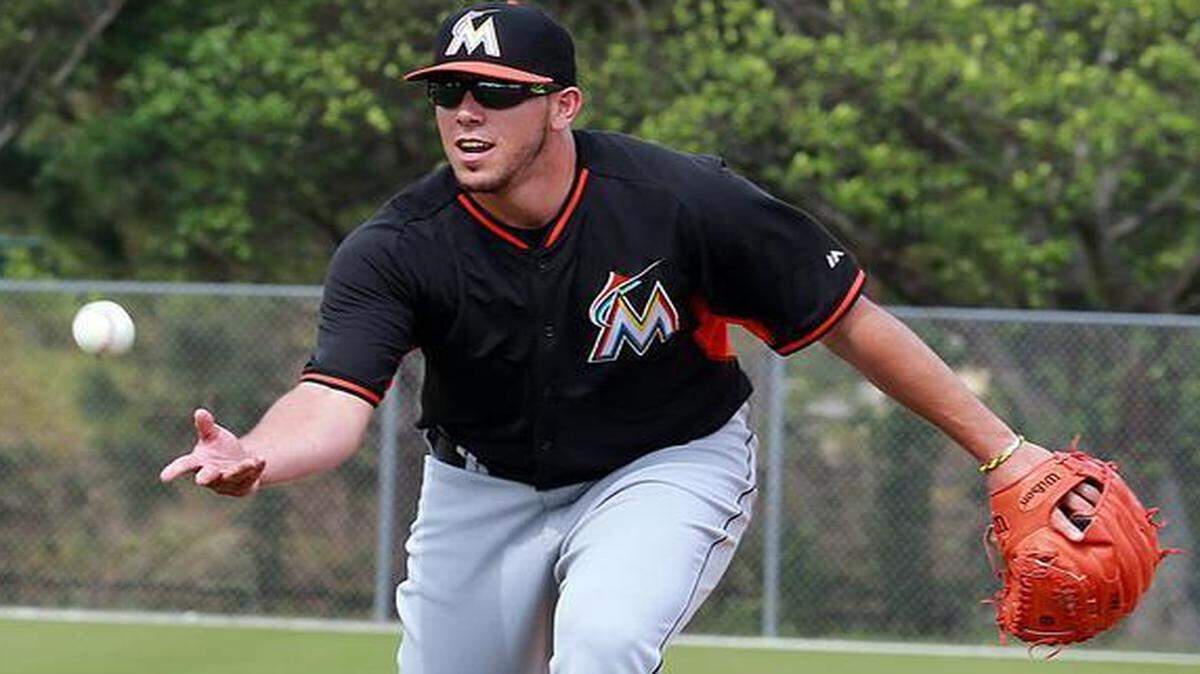 
Miami Marlins pitcher Jose Fernandez throws to first base during spring training full-squad workouts and game at Roger Dean Stadium in Jupiter on Tuesday, Feb. 24, 2015.
