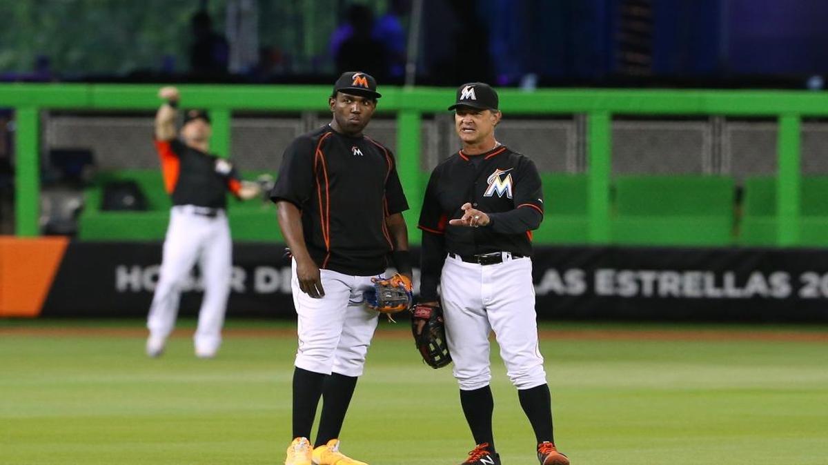 Miami Marlins manager Don Mattingly talks with Marlins center fielder Marcell Ozuna before the start of the game against the Colorado Rockies on June 17, 2016 at Marlins Park in Miami.