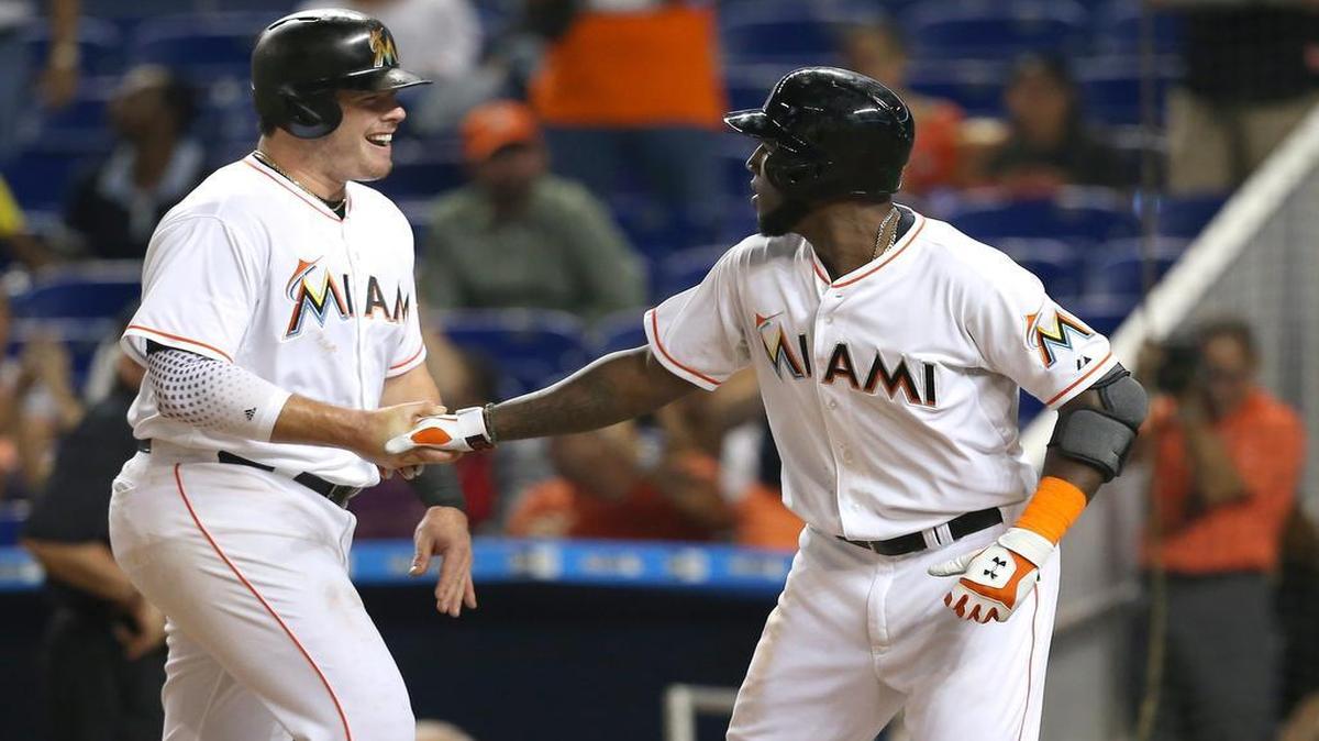 
Marcell Ozuna of the Miami Marlins is congratulated by Justin Bour, left, after hitting a two-run home run in the second inning of a baseball game against the Philadelphia Phillies on Thursday, August 20, 2015, at Marlins Park in Miami.
