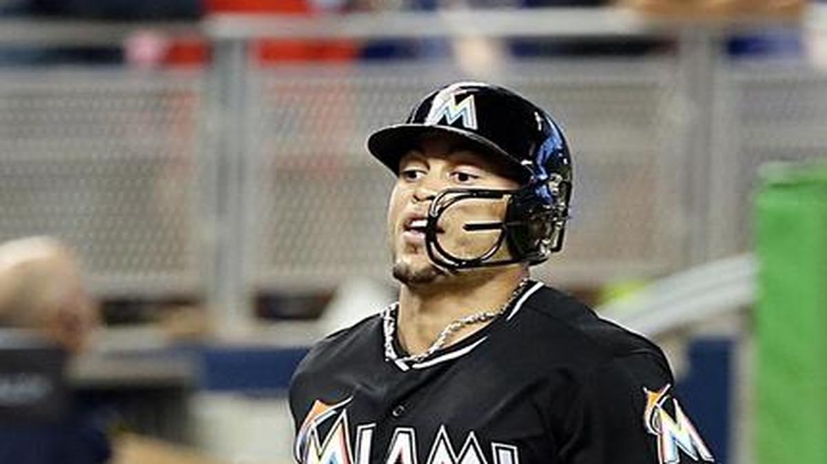 
Miami Marlins right fielder Giancarlo Stanton reaches home plate after hitting a two-run home run in the sixth inning of the team’s game against the Colorado Rockies at Marlins Park in Miami on June 13, 2015.
