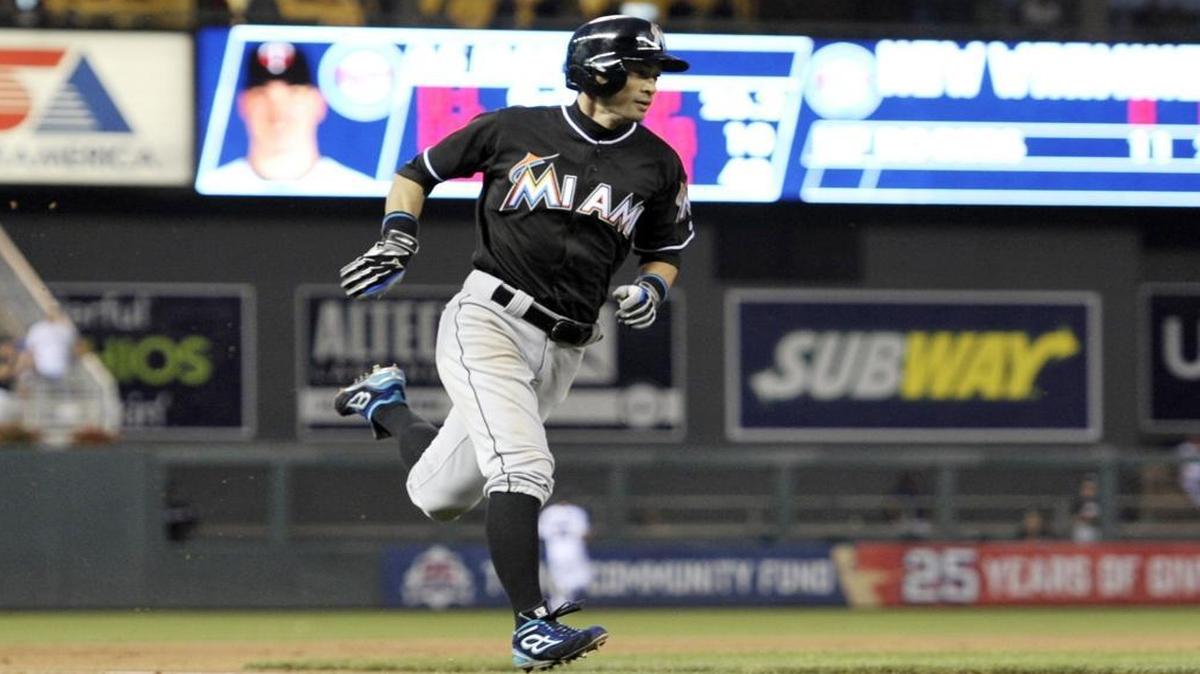 Miami Marlins' Ichiro Suzuki races home as he scores on a hit by Martin Prado off Minnesota Twins pitcher Trevor May during the seventh inning of a baseball game Thurs., June 9, 2016, in Minneapolis.