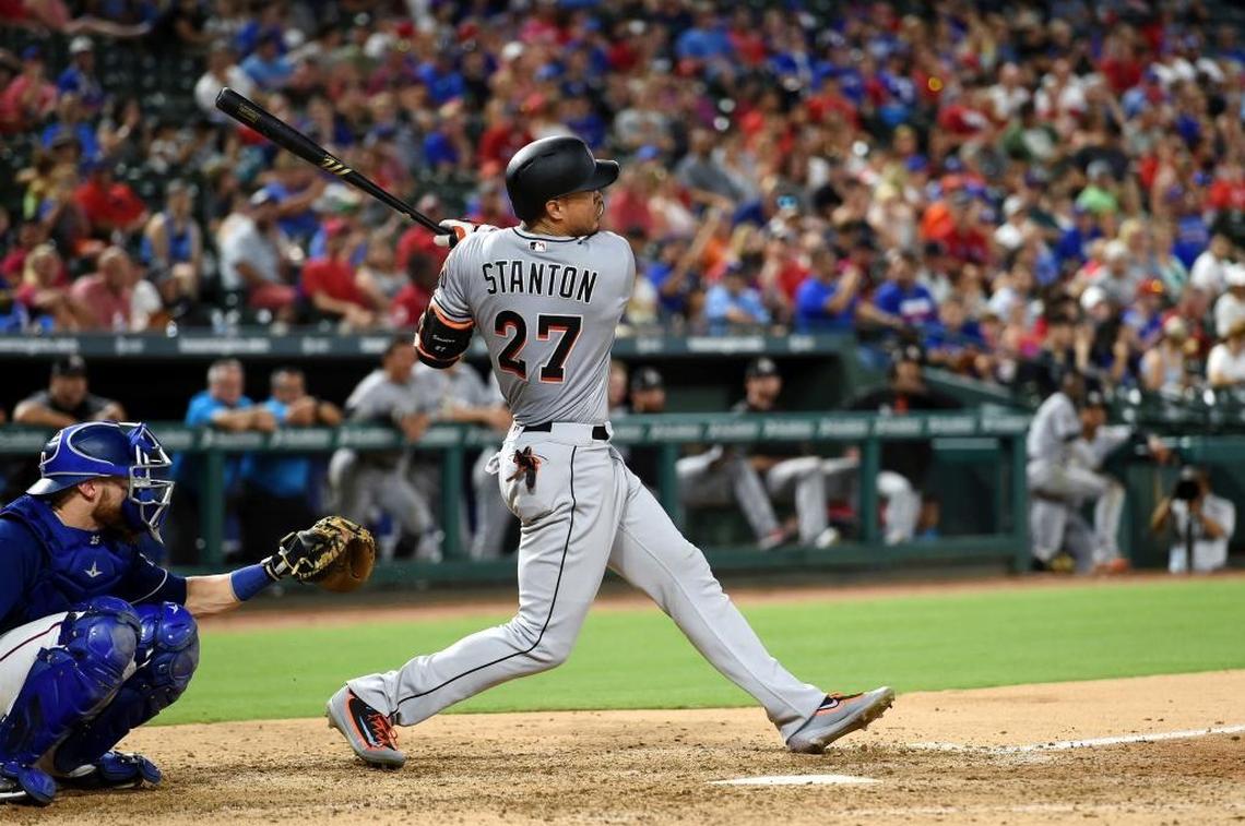 Miami Marlins right fielder Giancarlo Stanton (27) follows through on his second home run of a baseball game during the eighth inning against the Texas Rangers, Monday, July 24, 2017, in Arlington, Texas.