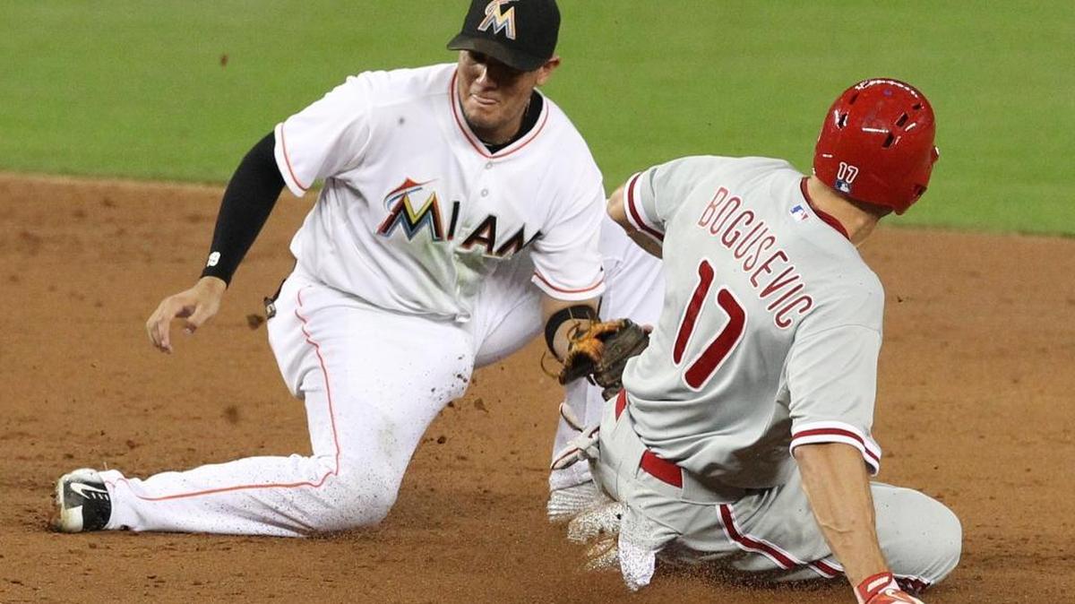 
Miami Marlins shortstop Miguel Rojas is too late with the tag as he tries to retire Brian Bogusevic of the Philadelphia Phillies in the third inning Tuesday, Sept. 22, 2015 at Marlins Park in Miami.
