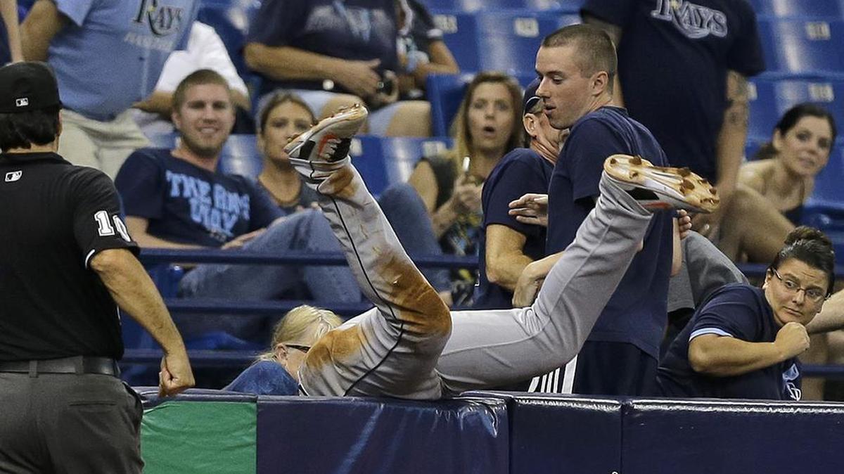 
Miami Marlins third baseman Martin Prado goes into the stands to make a catch on a pop out by Tampa Bay Rays' Mikie Mahtook during the seventh inning Tuesday, Sept. 29, 2015, in St. Petersburg, Fla. 
