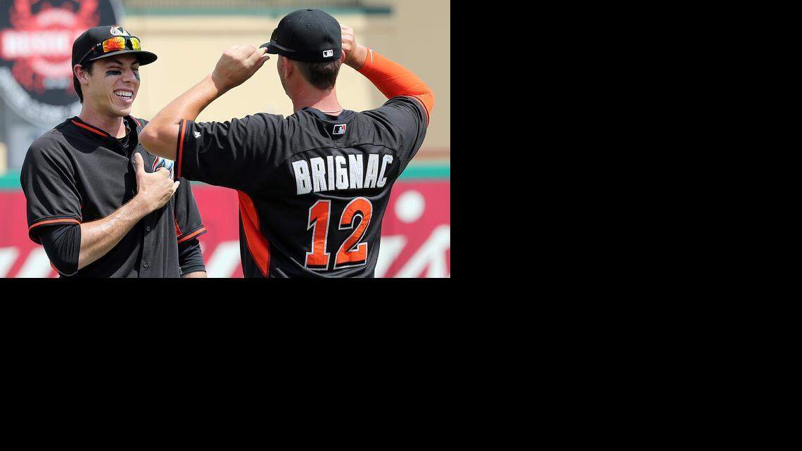 
Miami Marlins outfielder Christian Yelich and infielder Reid Brignac chat before the team’s game against the St. Louis Cardinals at Roger Dean Stadium in Jupiter on March 17, 2015.

