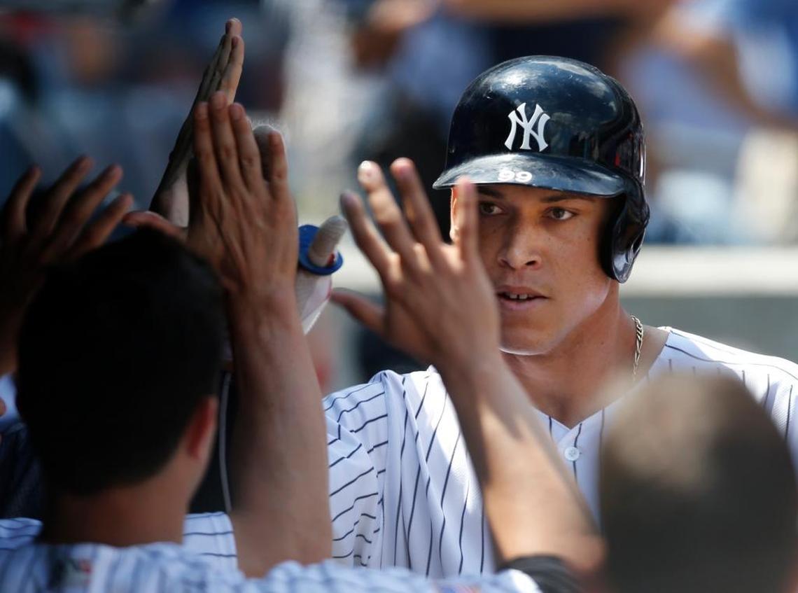 Teammates greet New York Yankees designated hitter Aaron Judge after he hit a solo home run during the fourth inning of a major league baseball game against the Toronto Blue Jays in New York, Tuesday, July 4, 2017.