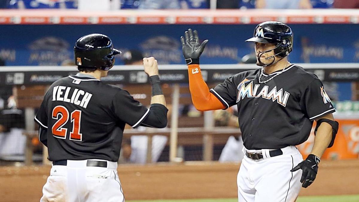 Christian Yelich (LF), high fives Giancarlo Stanton, (RF), for the Miami Marlins after his two run home runn the sixth inning of the Marlins against Colorado Rockies game at the Marlins Park on Saturday, June 13, 2015.