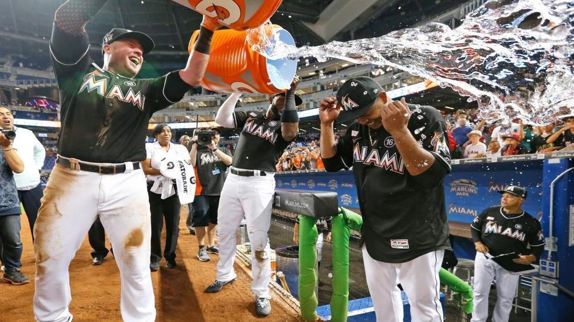 Miami Marlins' Justin Bour, left, and Marcell Ozuna, center rear, pour ice and water onto starting pitcher Edinson Volquez, right, after the Marlins defeated the Arizona Diamondbacks 3-0 in a no-hitter by Volquez during a baseball game, Sat., June 3, 2017, in Miami.