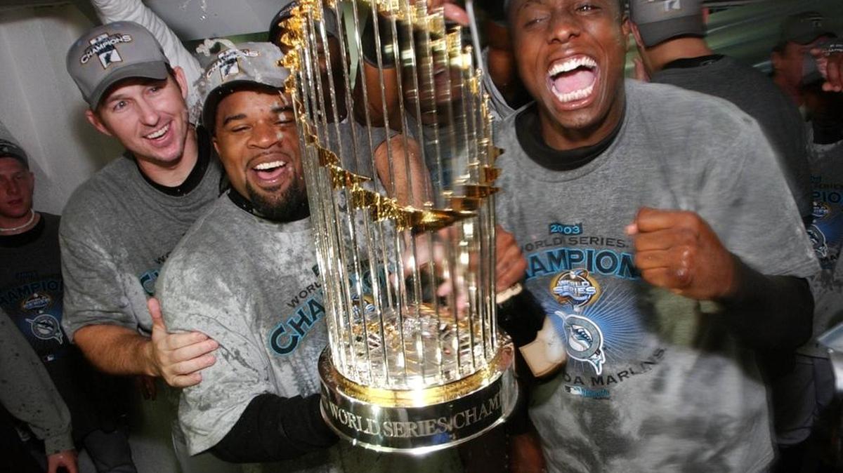 Florida Marlins Dontrelle Willis and Lenny Harris celebrate their 2003 World Series championship win at Yankee Stadium on Oct. 25, 2003.