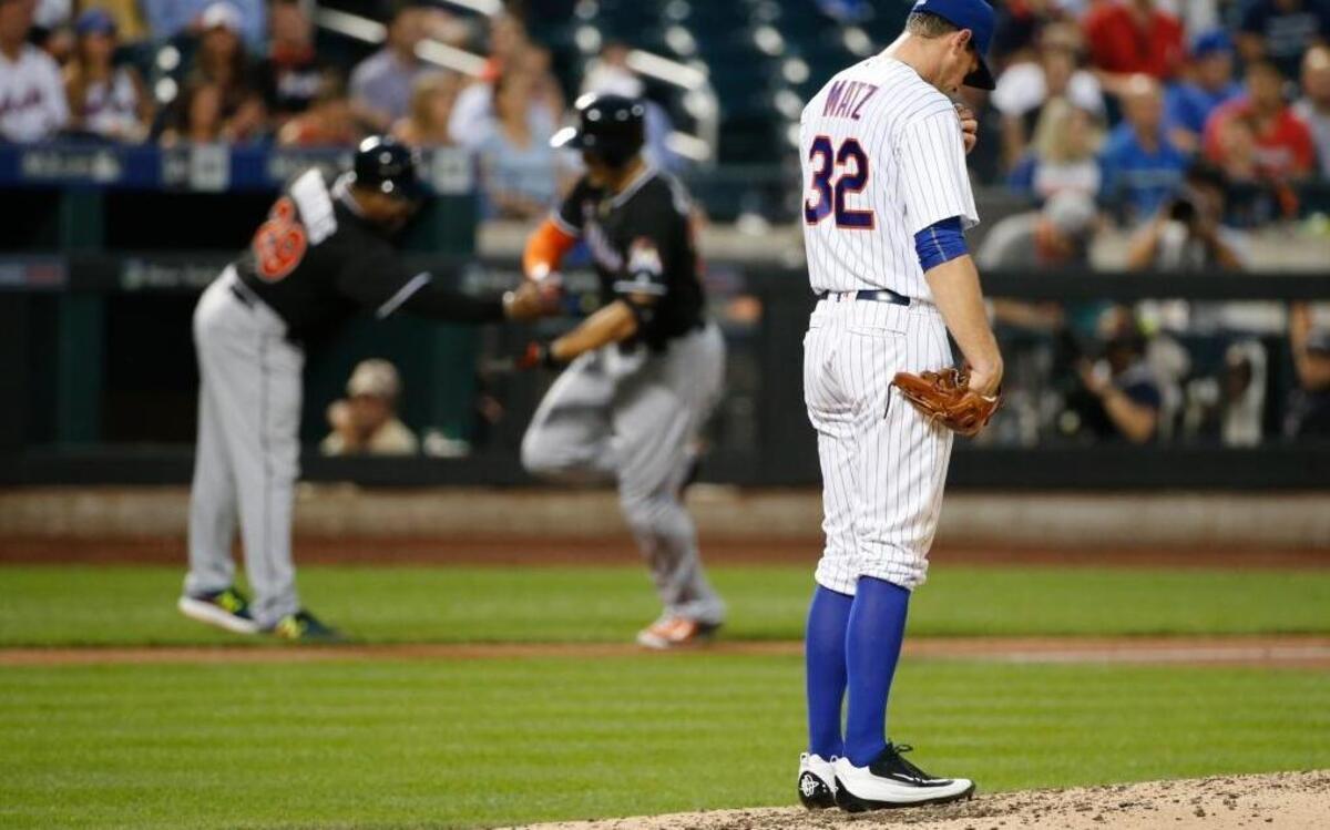 New York Mets starting pitcher Steven Matz looks down as Miami Marlins Giancarlo Stanton, center, runs the bases after hitting a seventh-inning, two-run, home run off Matz in a baseball game Tues., July 5, 2016, in New York.