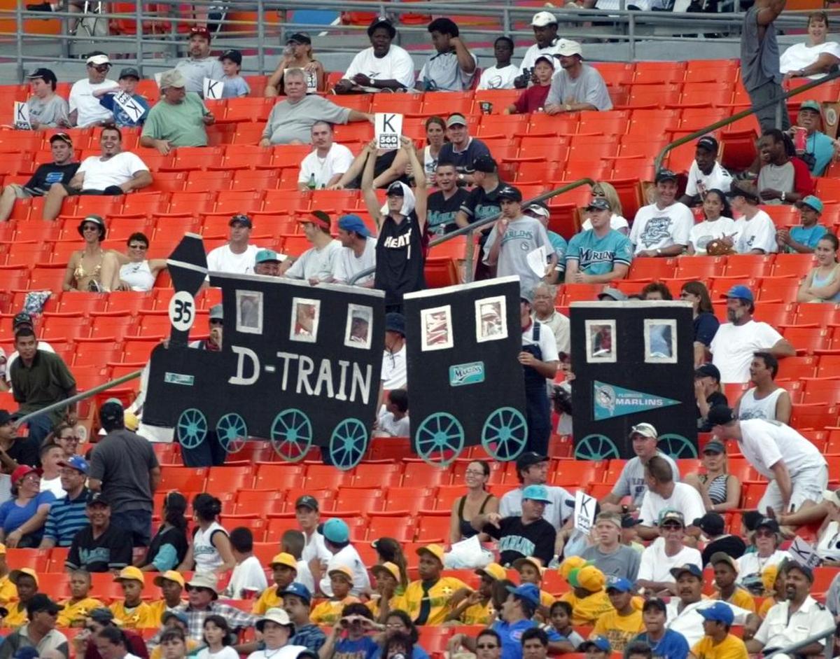 Fans of Florida Marlins pitcher Dontrelle Willis hold up signs during a game against the Chicago Cubs on July 20, 2003.