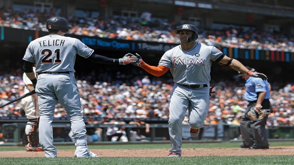 Miami Marlins' Giancarlo Stanton, right, is congratulated by Christian Yelich (21) after hitting a home run off San Francisco Giants' Johnny Cueto in the fifth inning of a baseball game, Sunday, July 9, 2017, in San Francisco.