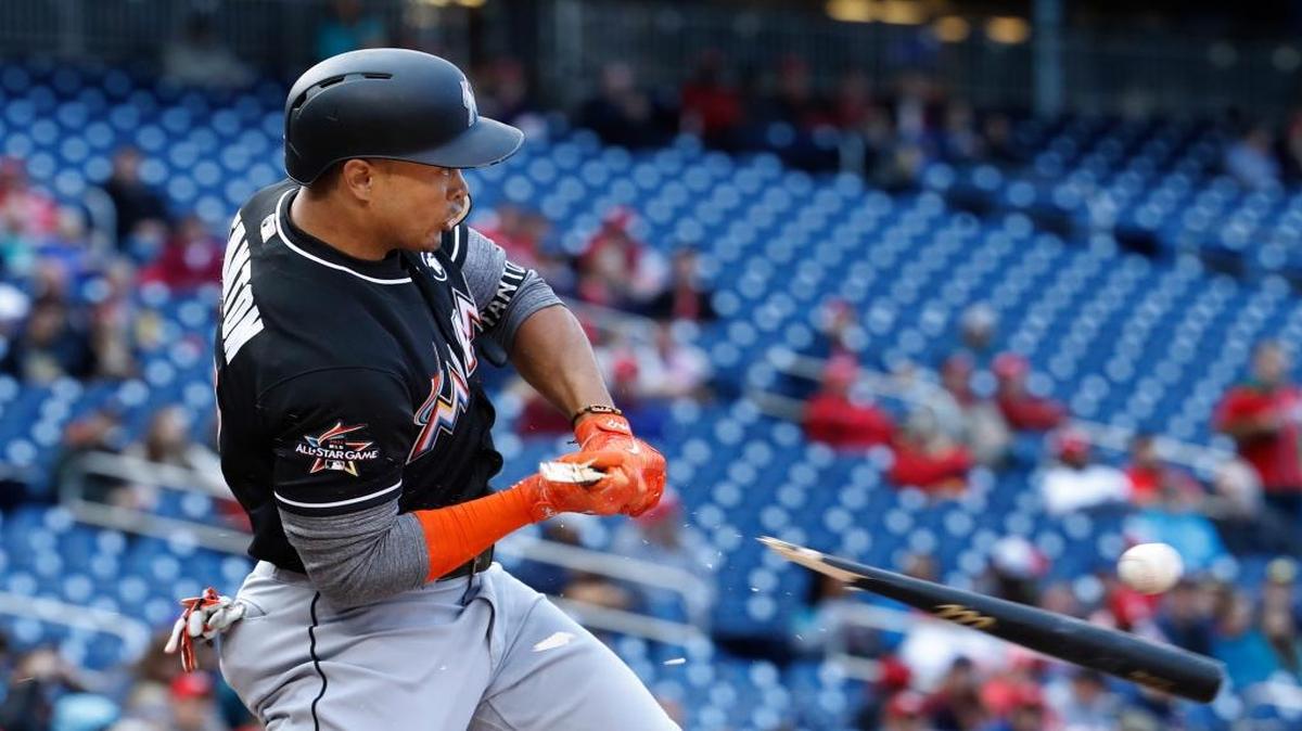 Miami Marlins' Giancarlo Stanton breaks his bat and grounds out to short during the fourth inning of the team's baseball game against the Washington Nationals in Washington, Thursday, April 6, 2017.