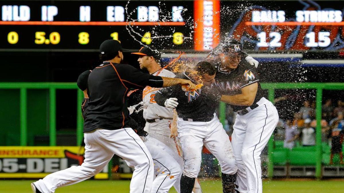 
Martin Prado, second from right, celebrates with teammates after getting the winning hit Saturday to snap an eight-game skid.
