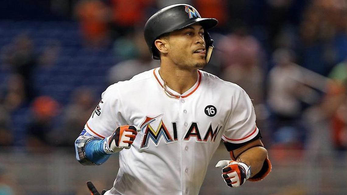 Giancarlo Stanton runs the bases and pumps his fist as he breaks the Marlins' season homerun record hitting his 43rd dinger of the season as the Miami Marlins host the San Francisco Giants on Monday, August 14, 2017.