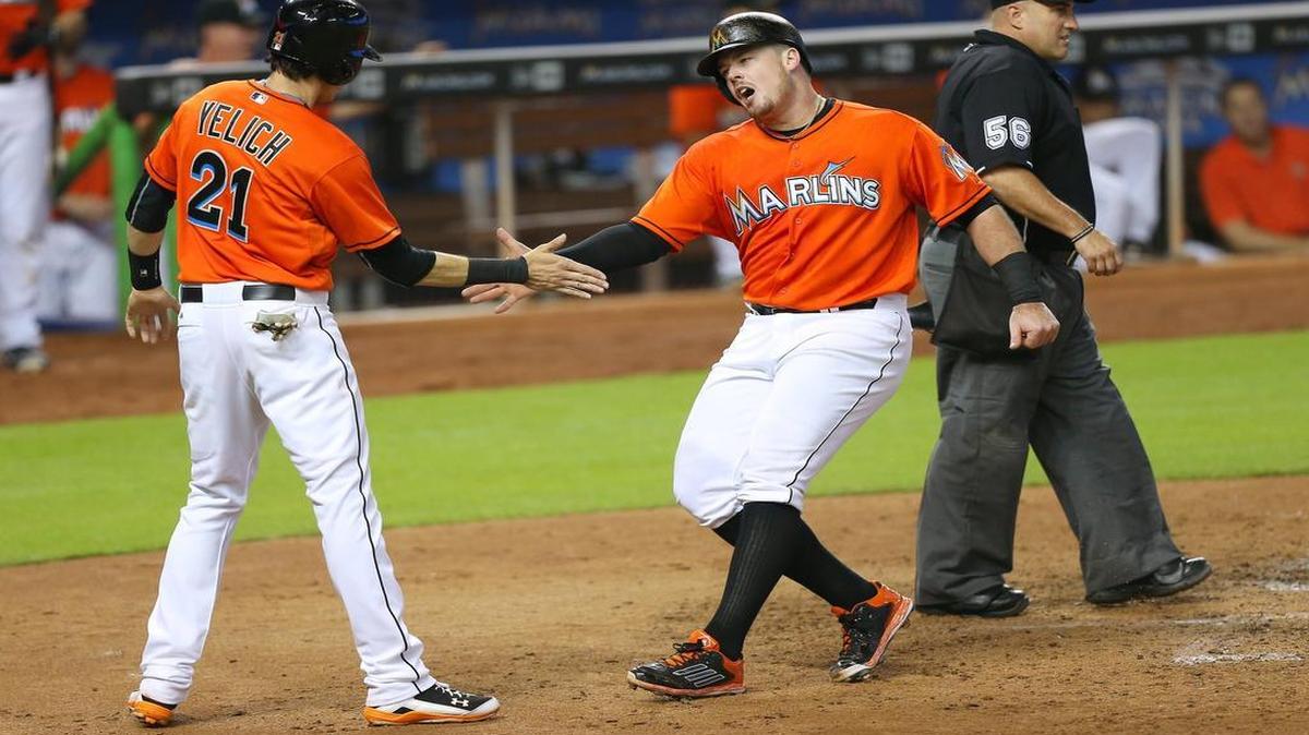 
Miami Marlins players Christian Yelich and Justin Bour celebrate after scoring on a two-run double by teammate Casey McGehee in the fourth inning of a baseball game on Sunday, July 12, 2015, at Marlins Park in Miami.
