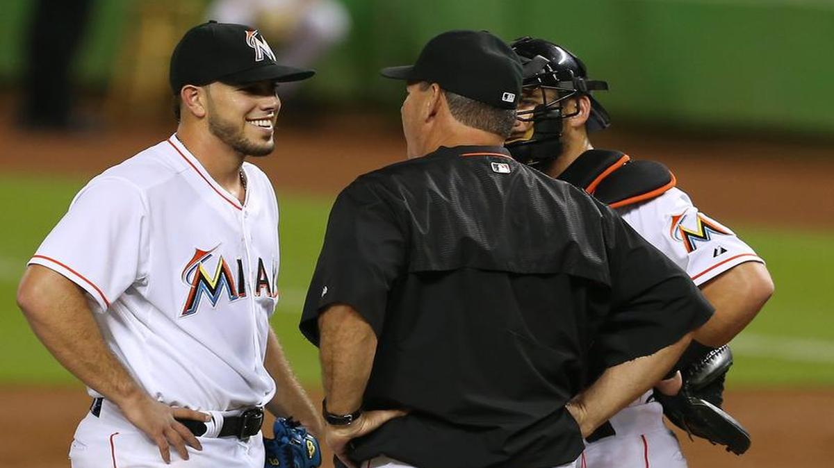 
Miami Marlins pitching coach Chuck Hernandez, center, speaks with Jose Fernandez and Jeff Mathis in the first inning of a baseball game against the Atlanta Braves on Friday, September 25, 2015, at Marlins Park in Miami.
