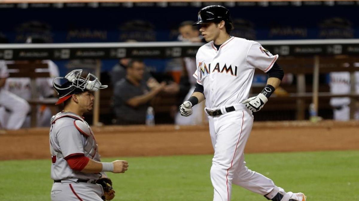 Miami Marlins' Christian Yelich crosses home plate after hitting a solo home run against the Washington Nationals in the seventh inning of a baseball game, Wed., Sept. 21, 2016, in Miami. The Nationals won 8-3.