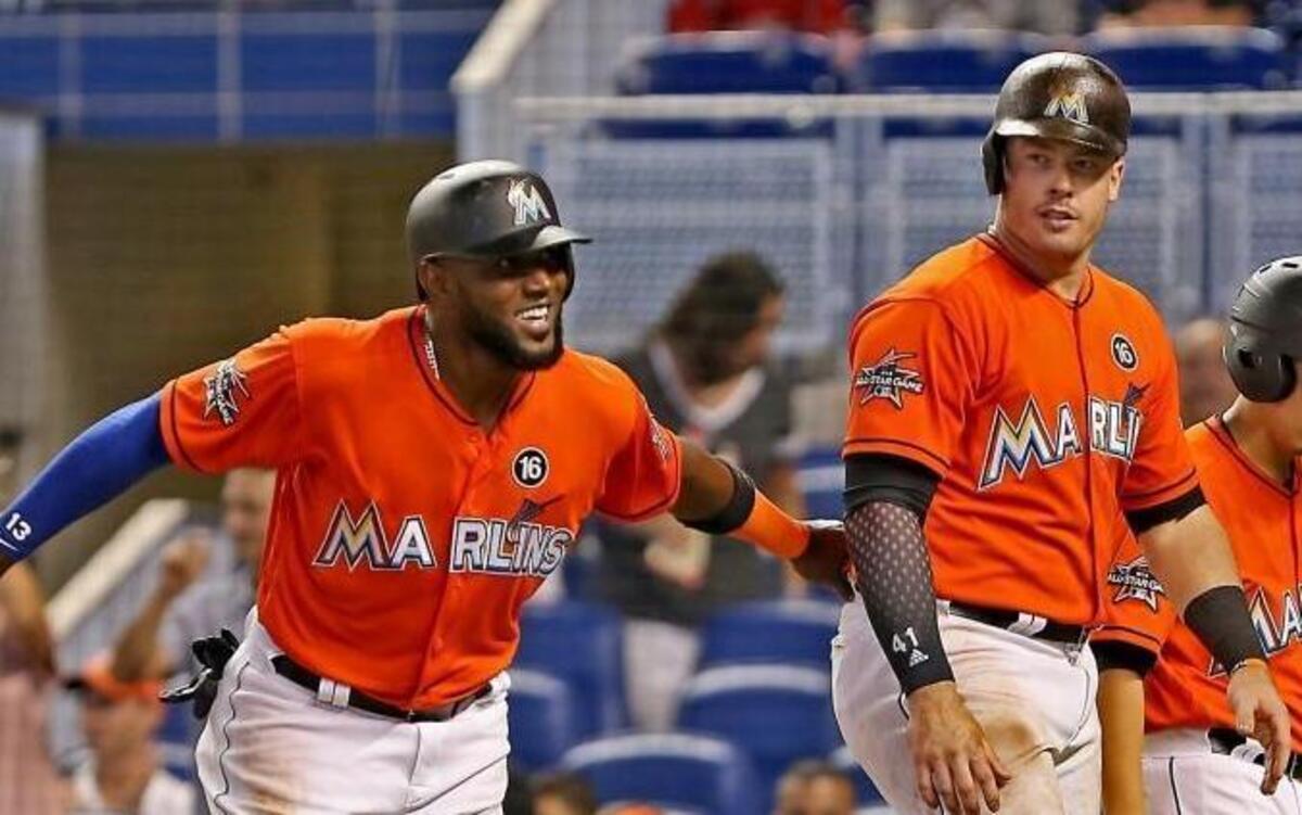 The Marlins' (13) Marcell Ozuna (left) celebrates Justin Bour's (center) 2-run homerun as the Miami Marlins host the Pittsburgh Pirates on Sunday, April 27, 2017.