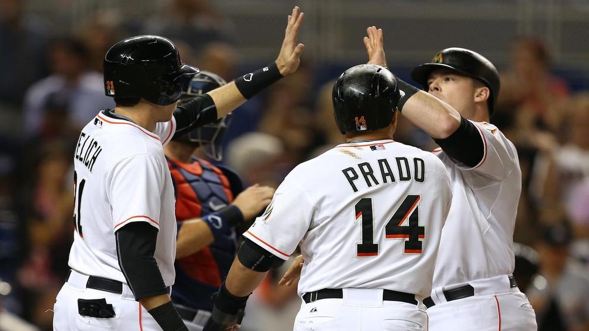Justin Bour, right, gets high-fives after hitting a three-run home run against the Braves on Friday night.