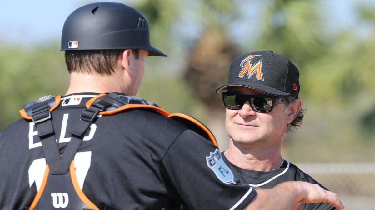 Miami Marlins manager Don Mattingly talks with catcher A.J. Ellis during training at the Marlins facility in Jupiter, Florida, February 15, 2017.