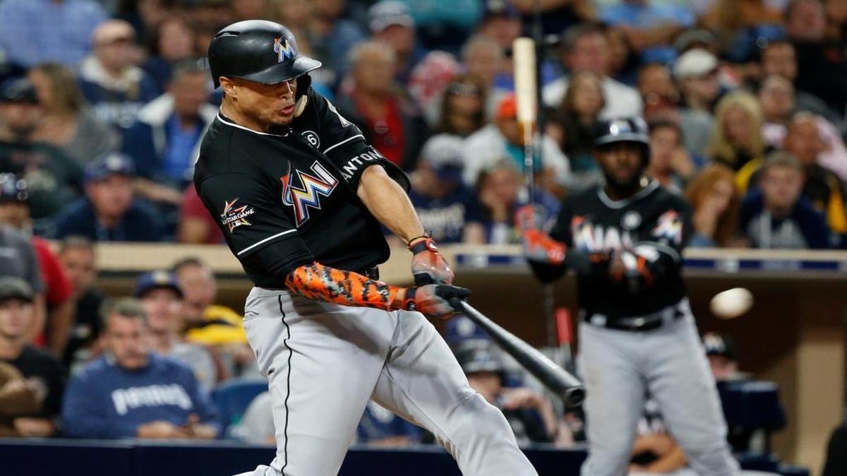 Miami Marlins' Giancarlo Stanton hits a two-run home run in the eleventh inning of a baseball game against the San Diego Padres in San Diego, Saturday, April 22, 2017. The Marlins won 6-3.
