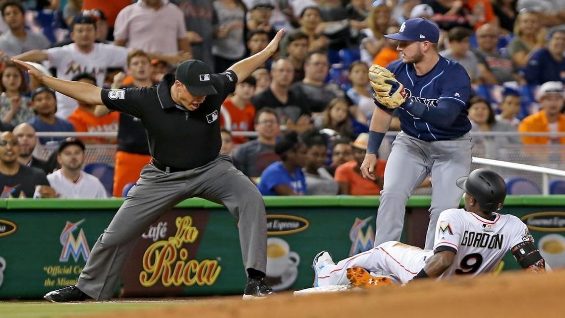 The Marlins' Dee Gordon slides safely into third base in the first inning as the Miami Marlins host the Tampa Bay Rays on Mon., May 1, 2017.