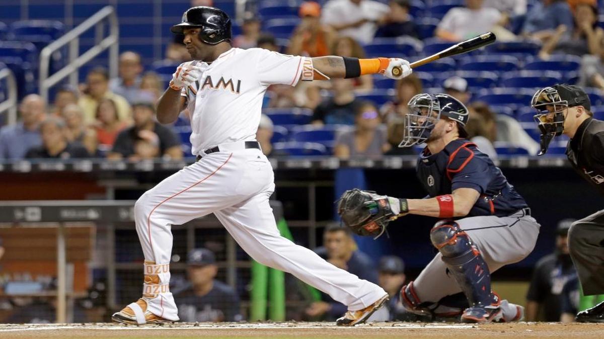 Miami Marlins' Marcell Ozuna follows through on a base hit against the Atlanta Braves in the first inning of a baseball game, Fri., Sept. 23, 2016, in Miami.