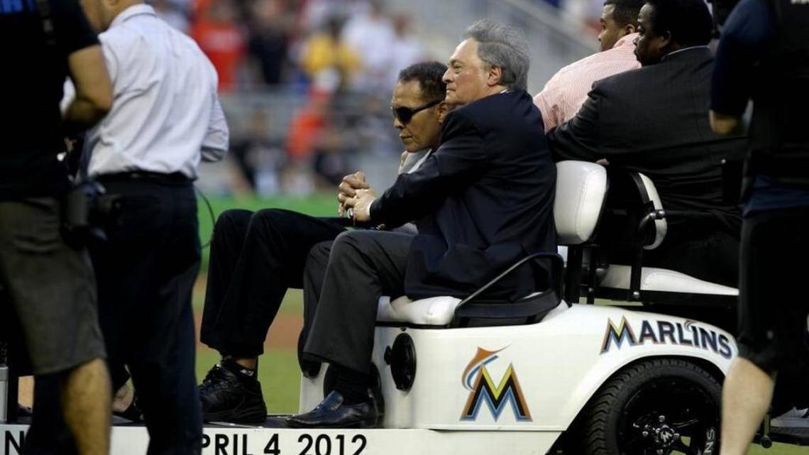 Marlins owner Jeffrey Loria rides onto the field at the opening of Marlins Park on April 4, 2012 with a feeble Muhammad Ali, who was too ill to throw out the ceremonial first pitch.