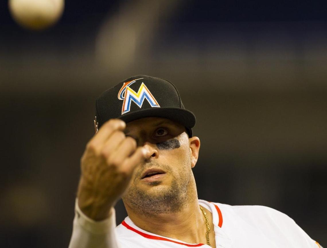 Marlins third baseman Martin Prado throws a ball to a fan as the Miami Marlins play the Philadelphia Phillies at Marlins Park on Mon., July 17, 2017.