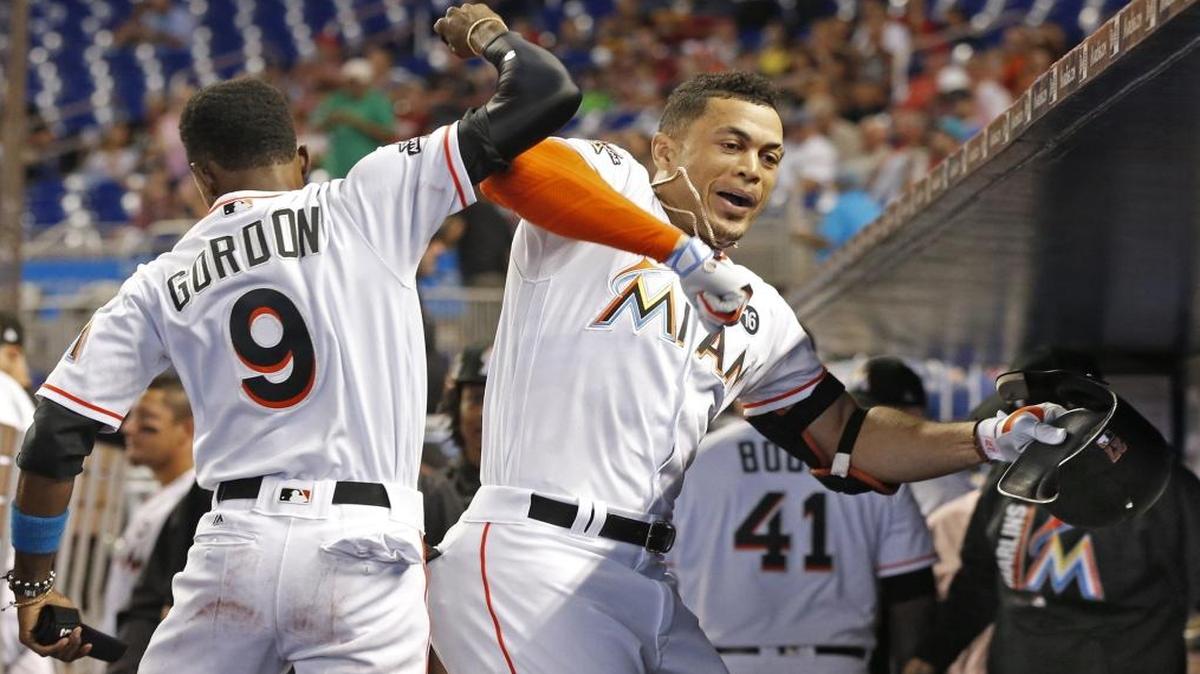 Miami Marlins right fielder Giancarlo Stanton (27) celebrates his home run hit with second baseman Dee Gordon (9) in the dugout in the first inning as the Miami Marlins play the Philadelphia Phillies at Marlins Park on Wed., July 19, 2017.