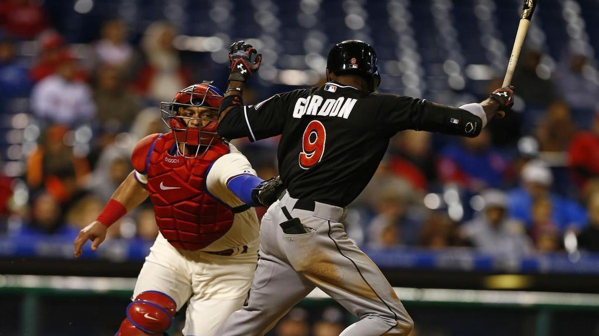 
Miami Marlins Dee Gordon is tagged out by Philadelphia Phillies catcher Carlos Ruiz on a ground ball that bounced off home plate during the ninth inning of the first game of a baseball doubleheader, Saturday, Oct. 3, 2015, in Philadelphia. The Marlins won 7-6. 

