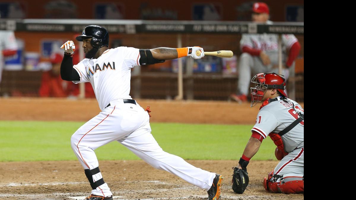 
Miami Marlins center fielder Marcell Ozuna hits a walk-off double in the ninth inning against the Philadelphia Phillies on Friday, May 1, 2015 at Marlins Park in Miami.
