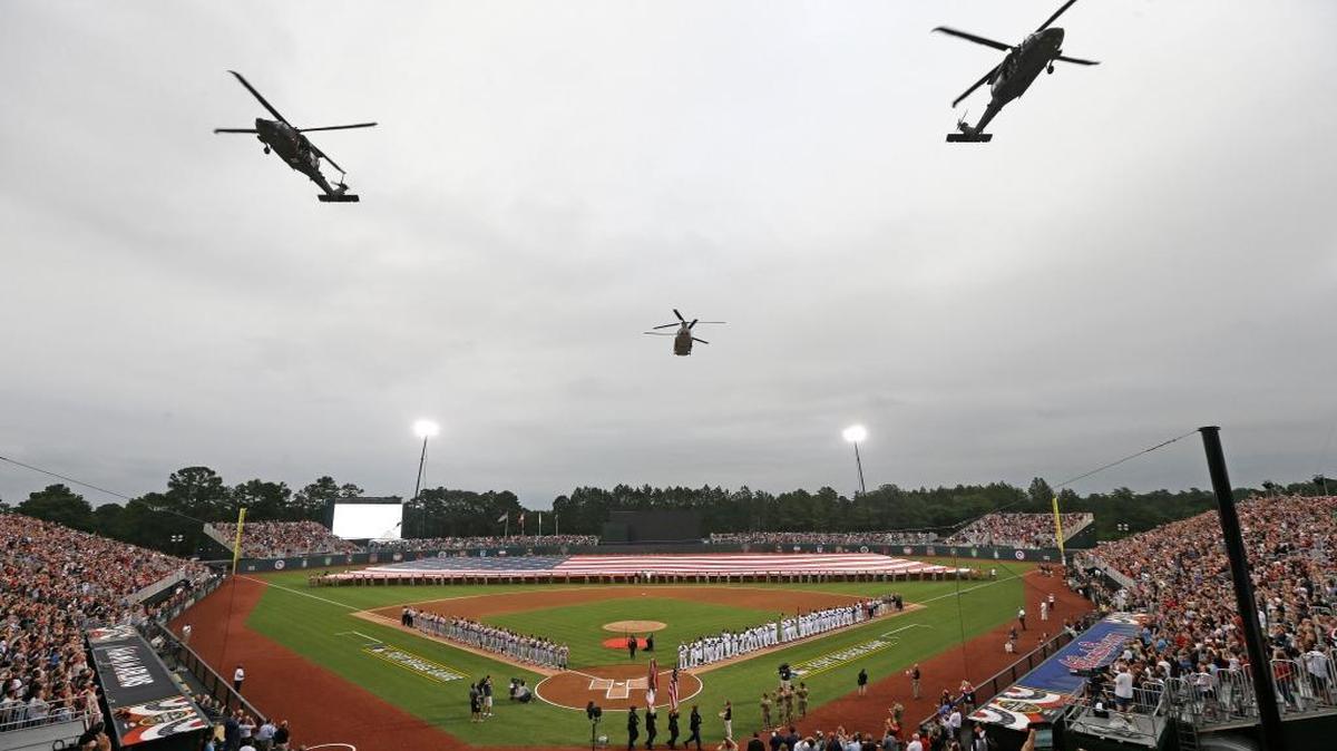 Helicopters fly over Fort Bragg Field prior to a baseball game between the Miami Marlins and the Atlanta Braves in Fort Bragg, N.C., Sunday, July 3, 2016.