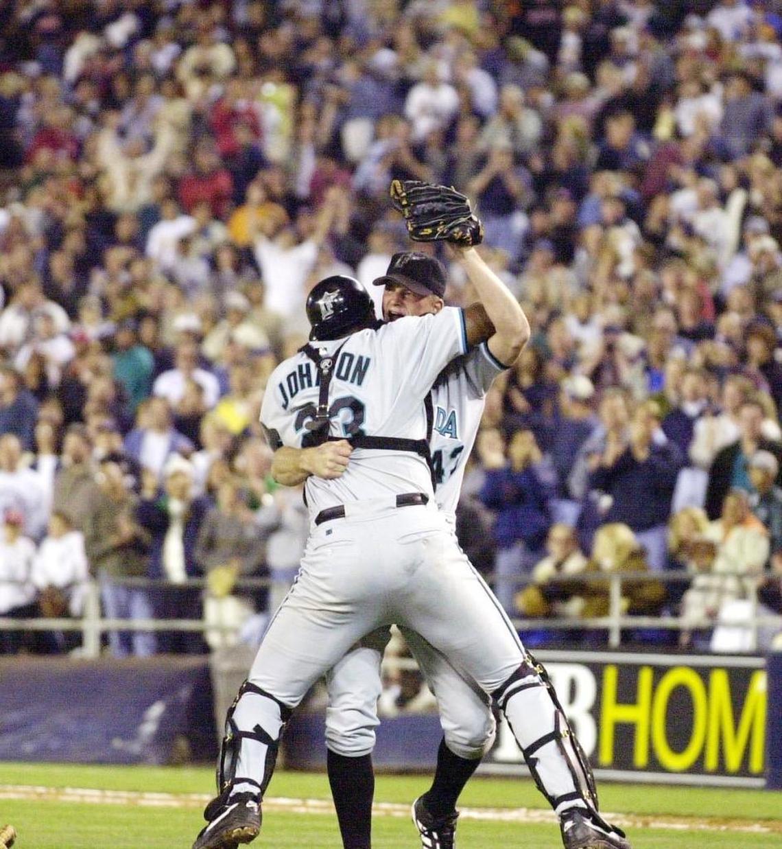 Florida Marlins pitcher A.J. Burnett is hugged by catcher Charles Johnson after completing a no-hitter against the San Diego Padres on Saturday, May 12, 2001, in San Diego.