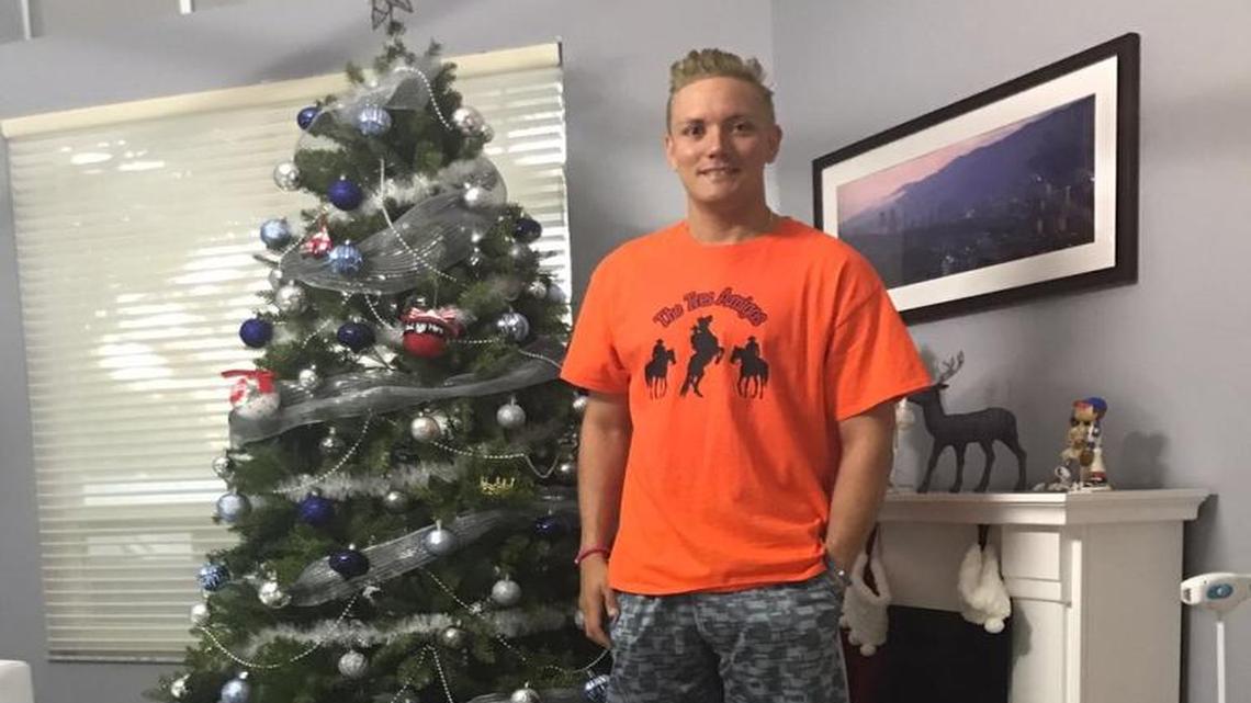 Miami Marlins infielder Miguel Rojas proudly wears his NFL fantasy league t-shirt. Rojas, who grew up in Venezuela and knew little about football, won the team’s fantasy league in a stunning upset.