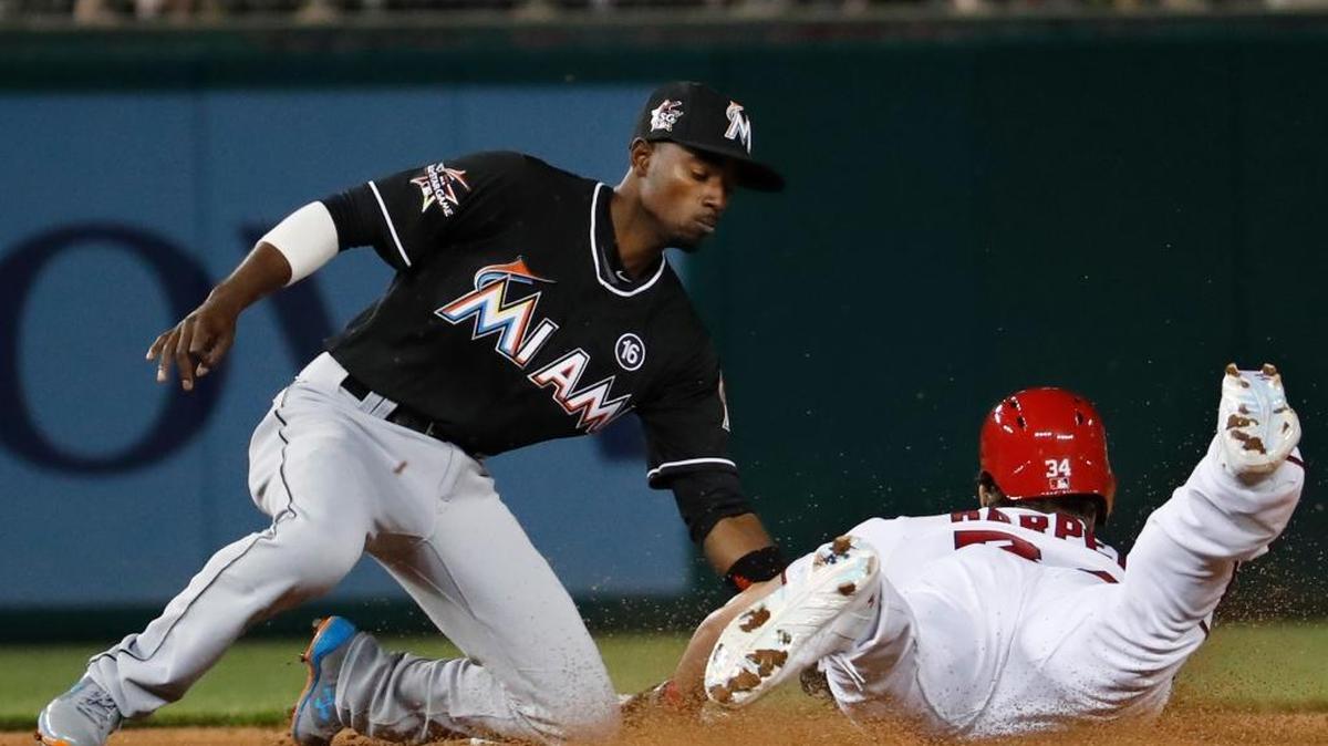Miami Marlins second baseman Dee Gordon (9) tag out Washington Nationals right fielder Bryce Harper (34) at second during the fifth inning of a baseball game in Washington, Wednesday, April 5, 2017.