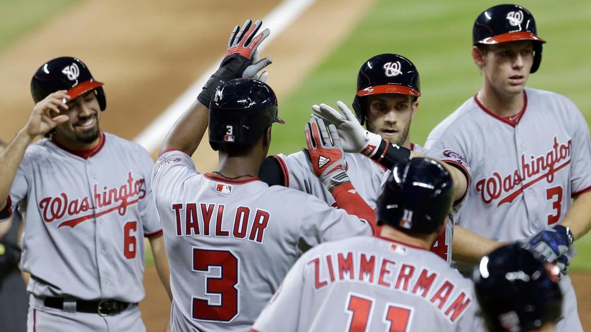 The Nationals’ Bryce Harper, second from right, is congratulated after victimizing Marlins reliever Chris Narveson again Tuesday night, when he hit a grand slam.