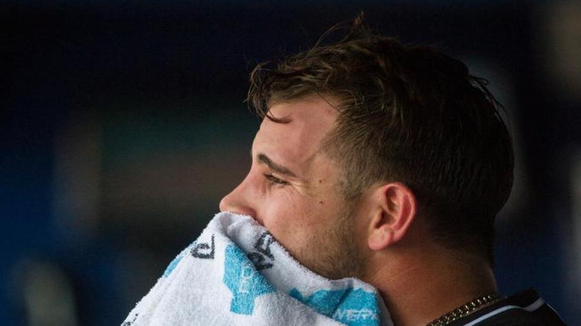 Miami Marlins pitcher Jose Fernandez sits in the dugout after being taken out after allowing 7 runs by the Atlanta Braves during the sixth inning of a baseball game, Saturday, July 2, 2016, in Atlanta.