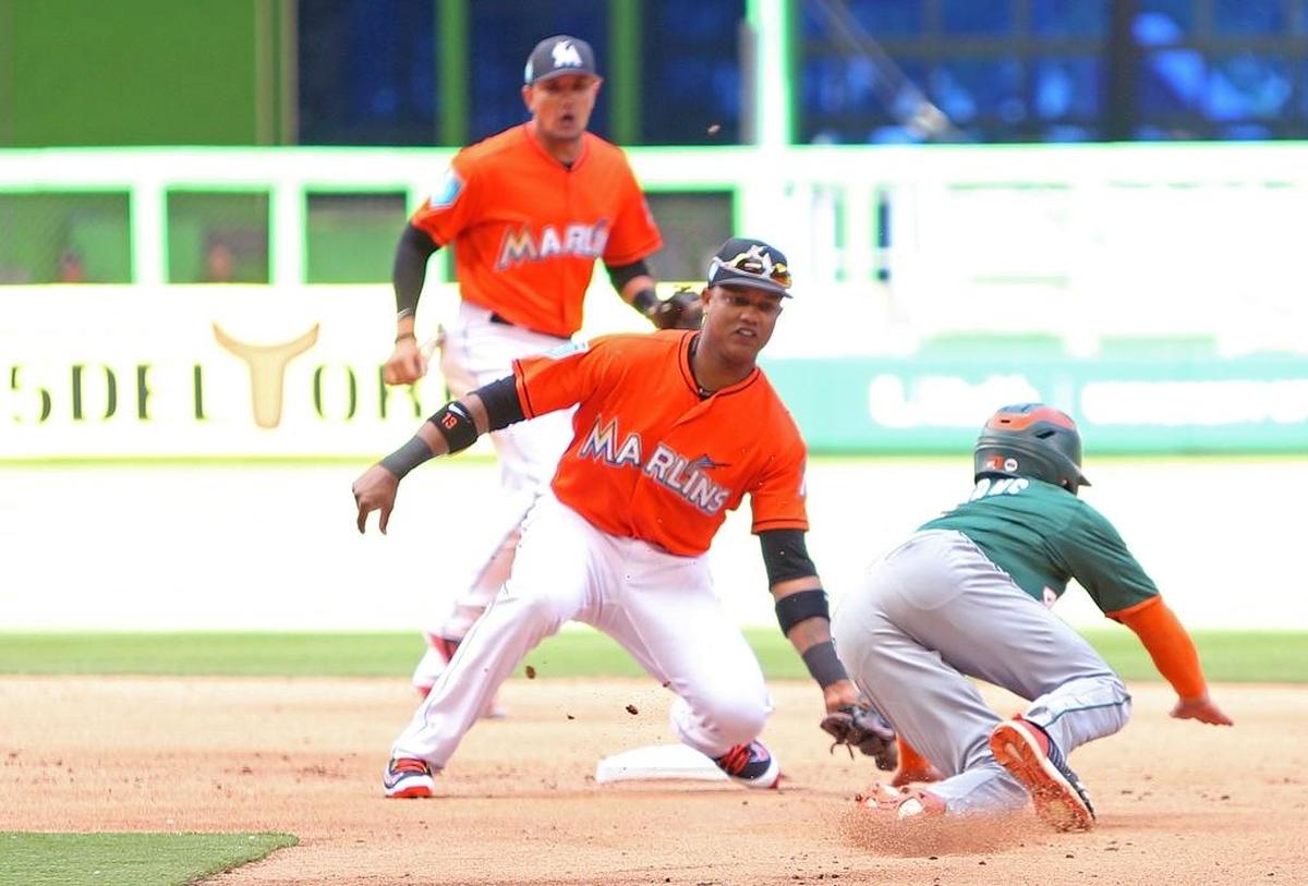 University of Miami Hurricanes center fielder Michael Burns is caught stealing as Miami Marlins second baseman Starlin Castro tag him out during the second inning of a exhibition baseball game at Marlins Park on Tues., March 27, 2018 in Miami.