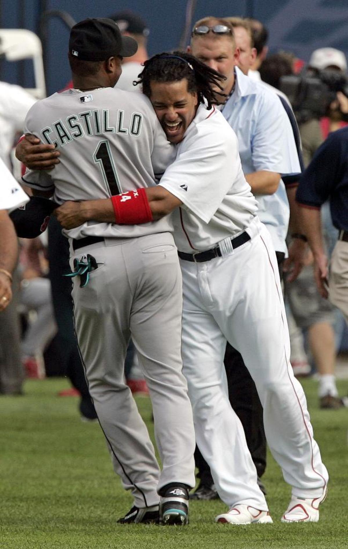 Manny Ramirez of the Red Sox gives Florida’s Luis Castillo a playful hug before the 2005 All-Star Game in Detroit.