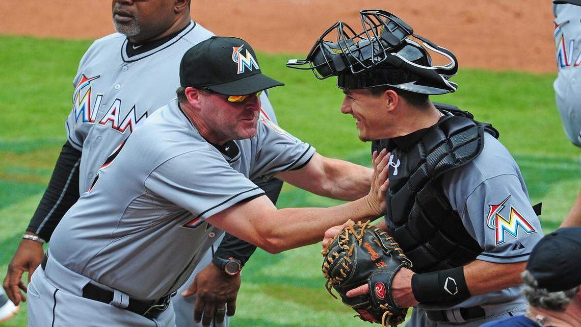 
Manager Mike Redmond #11 (L) of the Miami Marlins playfully shoves Catcher J. T. Realmuto #20 after the game against the Atlanta Braves at Turner Field on April 15, 2015 in Atlanta, Georgia.
