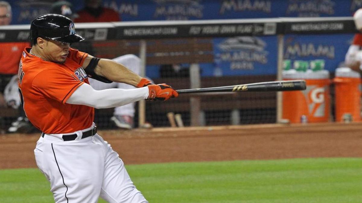 
Giancarlo Stanton hits a triple in the fifth inning during the Miami Marlins’ game against the Washington Nationals at Marlins Park on Sunday, April 26, 2015.
