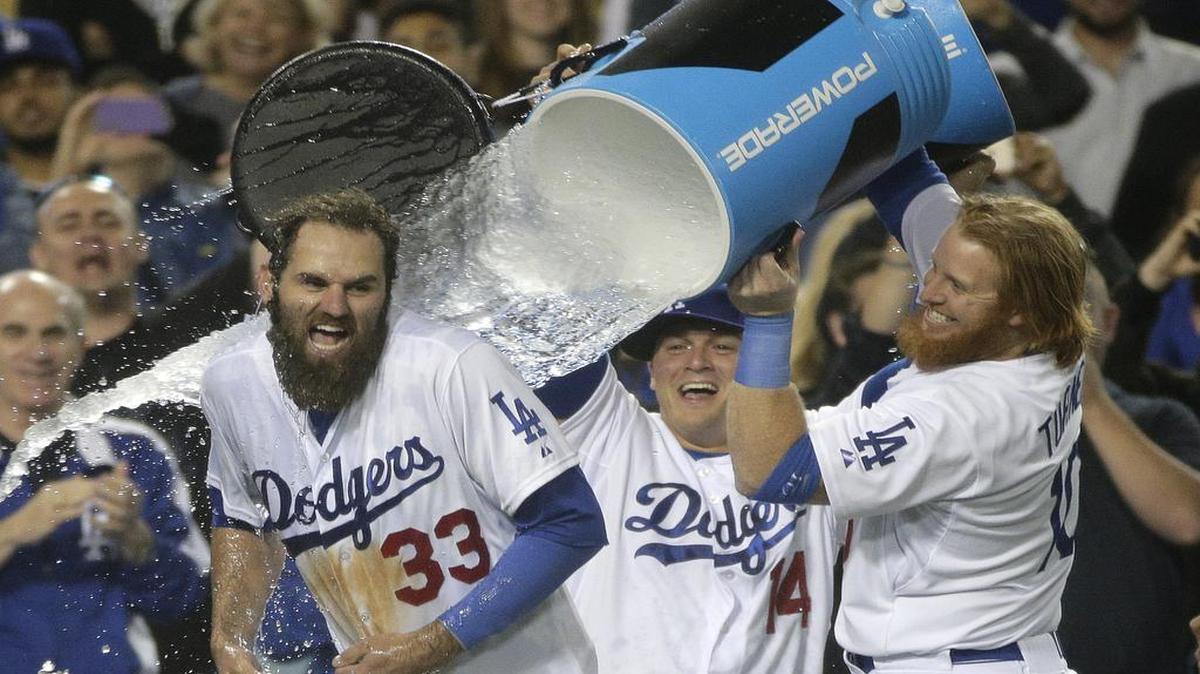 
Los Angeles Dodgers' Justin Turner, right, and Enrique Hernandez dumpwater on Scott Van Slyke, left, as they celebrate a three-run walk off home run by Van Slyke in a baseball game against the Miami Marlins, Monday, May 11, 2015, in Los Angeles. The Dodgers won 5-3. 
