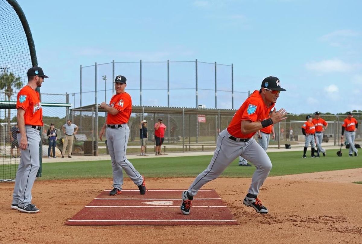 Miami Marlins outfielder Derek Dietrich runs into first base during the spring training baseball workouts at Roger Dean Stadium on Tues., Feb. 20, 2018 in Jupiter, FL.