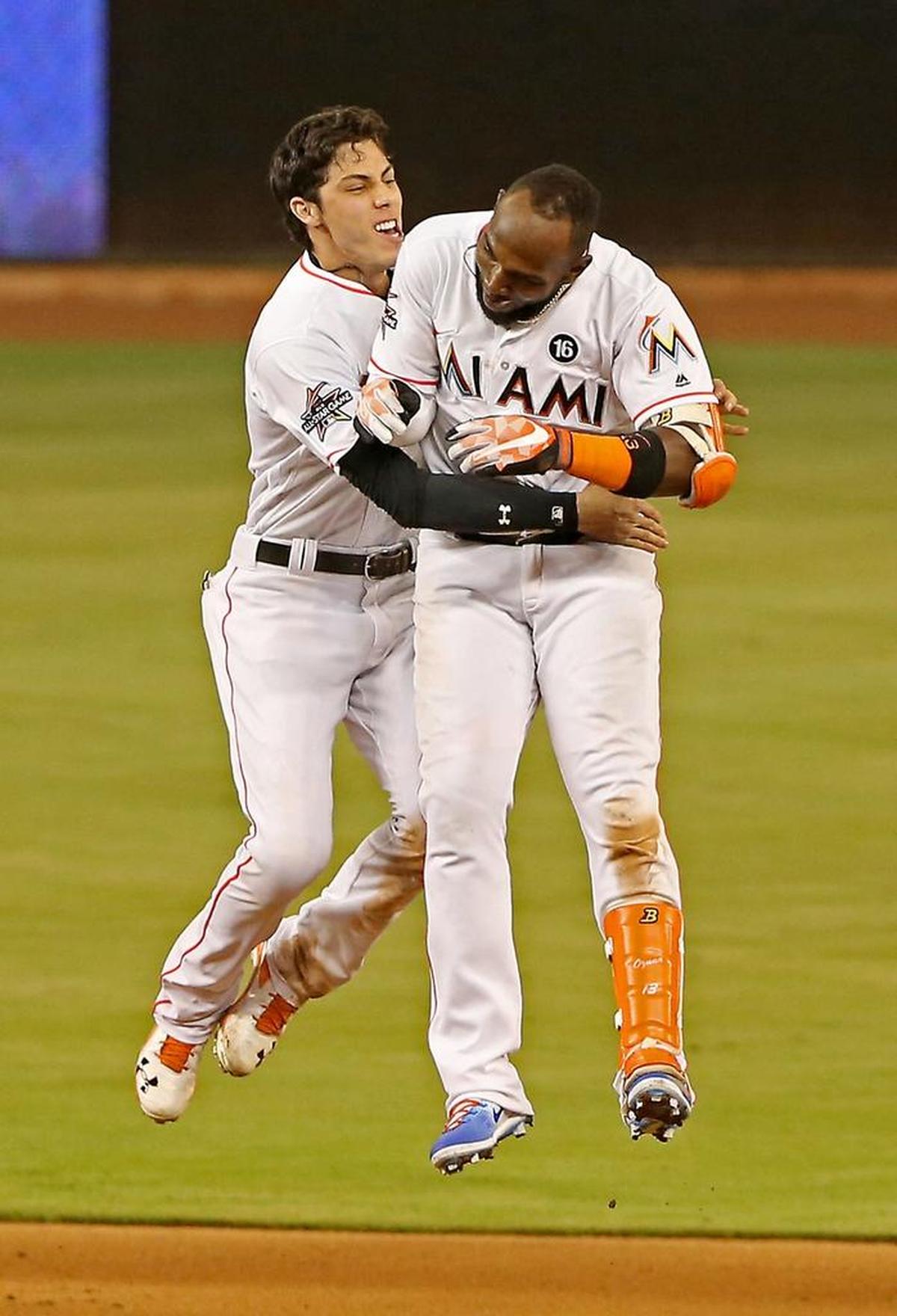 Miami’s Christian Yelich celebrates with Marcell Ozuna after he drove in Dee Gordon with the game-winning run against the Nationals on June 19.