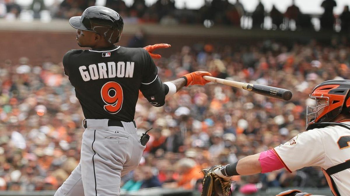 
Miami Marlins' Dee Gordon doubles off San Francisco Giants starting pitcher Ryan Vogelsong in the third inning of their baseball game against the San Francisco Giants Sunday, May 10, 2015, in San Francisco. At right is Giants catcher Andrew Susac. 
